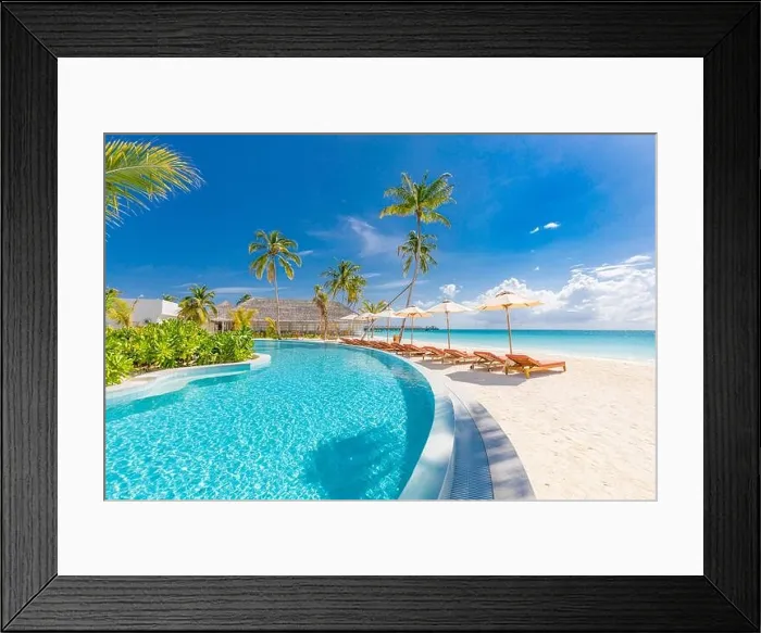 Framed Print : Beach landscape. Luxurious beach resort with swimming pool and beach chairs or loungers under umbrellas with palm trees, vacation, travel holiday Framed Print : Beach landscape. Luxurious beach resort with swimming pool and beach chairs or loungers under umbrellas with palm trees, vacation, travel holiday