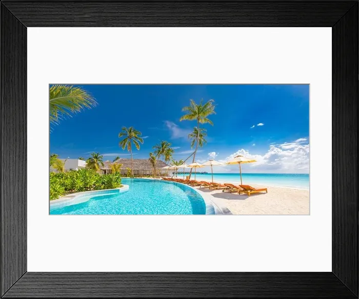 Framed Print : Beach landscape. Luxurious beach resort with swimming pool and beach chairs or loungers under umbrellas with palm trees, vacation, travel holiday Framed Print : Beach landscape. Luxurious beach resort with swimming pool and beach chairs or loungers under umbrellas with palm trees, vacation, travel holiday