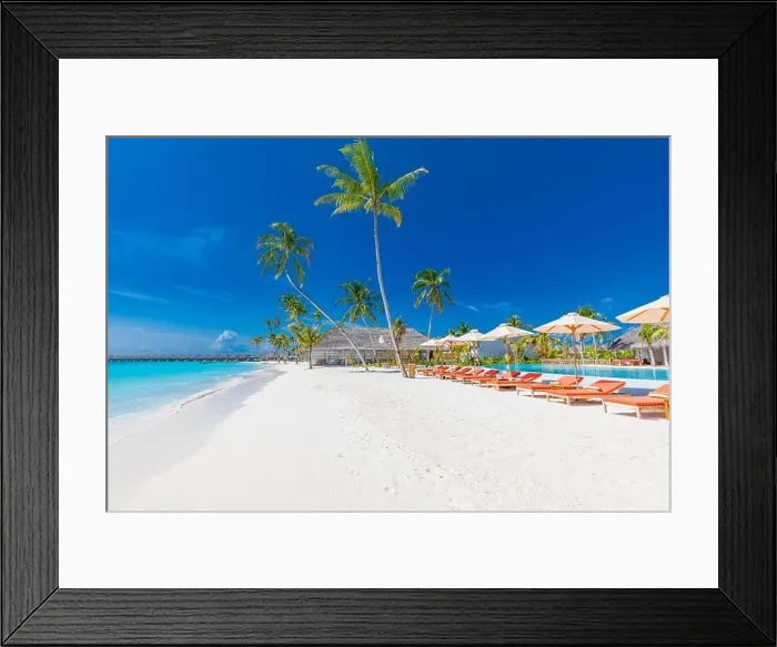 Framed Print : Beach landscape. Luxurious beach resort with swimming pool and beach chairs or loungers under umbrellas with palm trees, vacation, travel holiday Framed Print : Beach landscape. Luxurious beach resort with swimming pool and beach chairs or loungers under umbrellas with palm trees, vacation, travel holiday