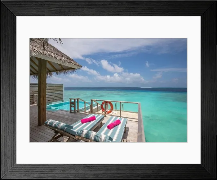 Framed Print : Fantastic over water villa, terrace view with sun beds chairs under umbrella, luxury pool hotel with stunning ocean view. Beautiful spa or wellness Framed Print : Fantastic over water villa, terrace view with sun beds chairs under umbrella, luxury pool hotel with stunning ocean view. Beautiful spa or wellness