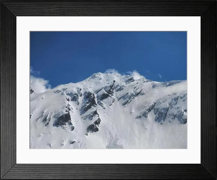 Framed Print : Winter in the rocky mountains covered with snow against blue sky with small clouds Framed Print : Winter in the rocky mountains covered with snow against blue sky with small clouds