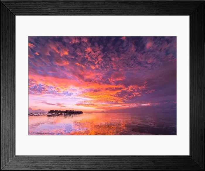 Framed Print : Sunset on Maldives island, luxury water villas resort and wooden pier. Beautiful sky and clouds and beach background for summer vacation holiday Framed Print : Sunset on Maldives island, luxury water villas resort and wooden pier. Beautiful sky and clouds and beach background for summer vacation holiday