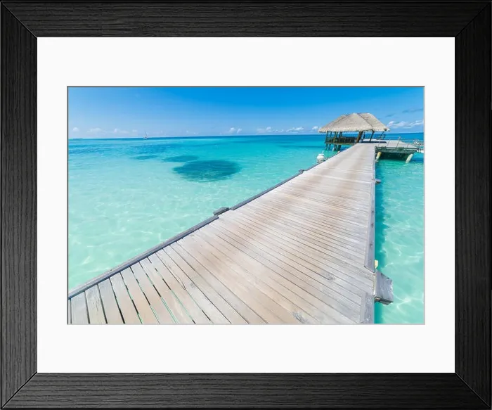 Framed Print : Luxury over water bungalows in tropical sea under blue sky. Tranquil vacation background Framed Print : Luxury over water bungalows in tropical sea under blue sky. Tranquil vacation background