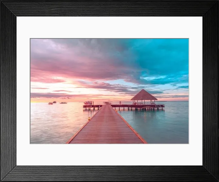 Framed Print : Sunset on Maldives island, luxury water villas resort and wooden pier. Beautiful sky and clouds and beach background for summer vacation holiday
