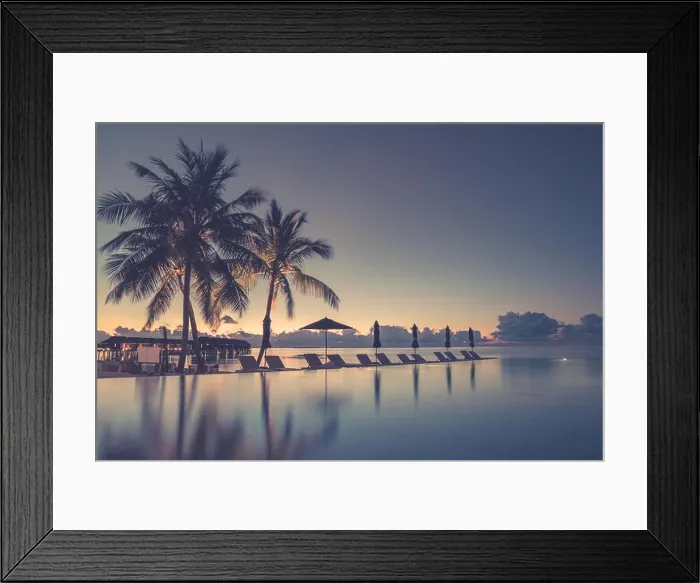 Framed Print : Luxury infinity beach pool in sunset time. Palm trees and calm weather on the beach. Summer vacation and holiday concept Framed Print : Luxury infinity beach pool in sunset time. Palm trees and calm weather on the beach. Summer vacation and holiday concept