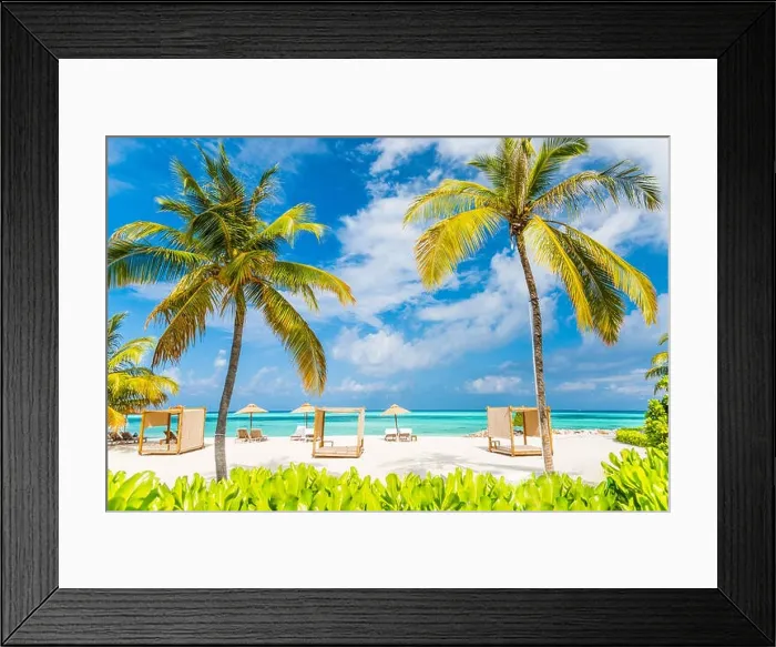 Framed Print : Tropical beach scene, loungers and beach canopy under palm trees and blue sky. Summer vacation and holiday concept Framed Print : Tropical beach scene, loungers and beach canopy under palm trees and blue sky. Summer vacation and holiday concept