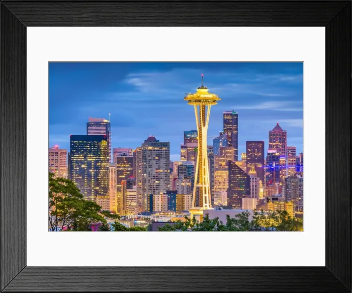 Framed Print : SEATTLE, WASHINGTON - JUNE 26, 2018: The Space Needle towers in front of the downtown Seattle skyline at dusk Framed Print : SEATTLE, WASHINGTON - JUNE 26, 2018: The Space Needle towers in front of the downtown Seattle skyline at dusk