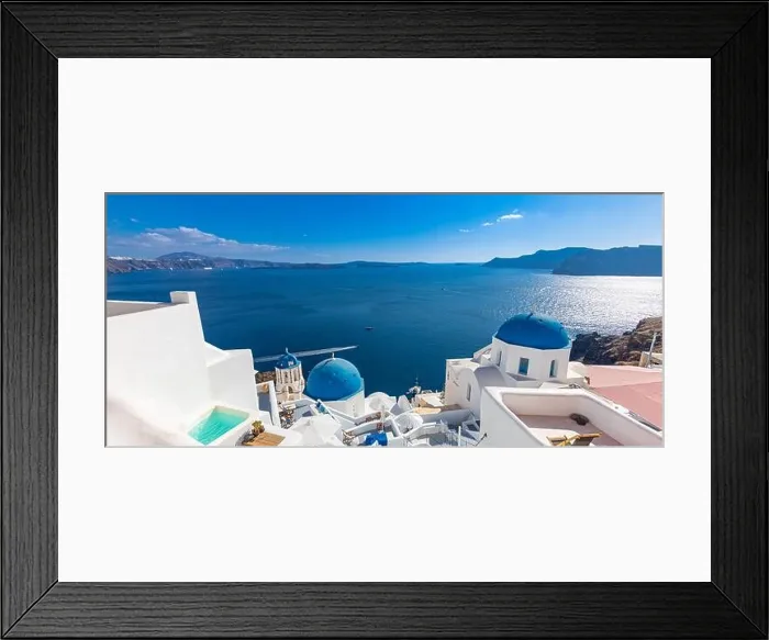 Framed Print : Luxury travel vacation. Oia town on Santorini island, Greece. Traditional and famous houses and churches with blue domes over the Caldera, Aegean sea Framed Print : Luxury travel vacation. Oia town on Santorini island, Greece. Traditional and famous houses and churches with blue domes over the Caldera, Aegean sea