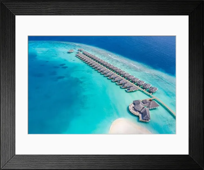 Framed Print : Perfect aerial landscape, luxury tropical resort or hotel with water villas and beautiful beach scenery. Amazing bird eyes view in Maldives, landscape Framed Print : Perfect aerial landscape, luxury tropical resort or hotel with water villas and beautiful beach scenery. Amazing bird eyes view in Maldives, landscape