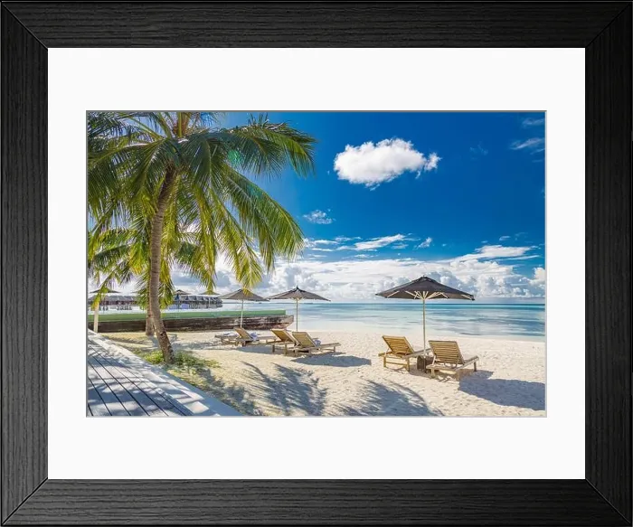 Framed Print : Tourism vacation landscape. Luxurious beach resort and beach chairs or loungers under umbrellas with palm trees and blue sky. Summer leisure carefree Framed Print : Tourism vacation landscape. Luxurious beach resort and beach chairs or loungers under umbrellas with palm trees and blue sky. Summer leisure carefree