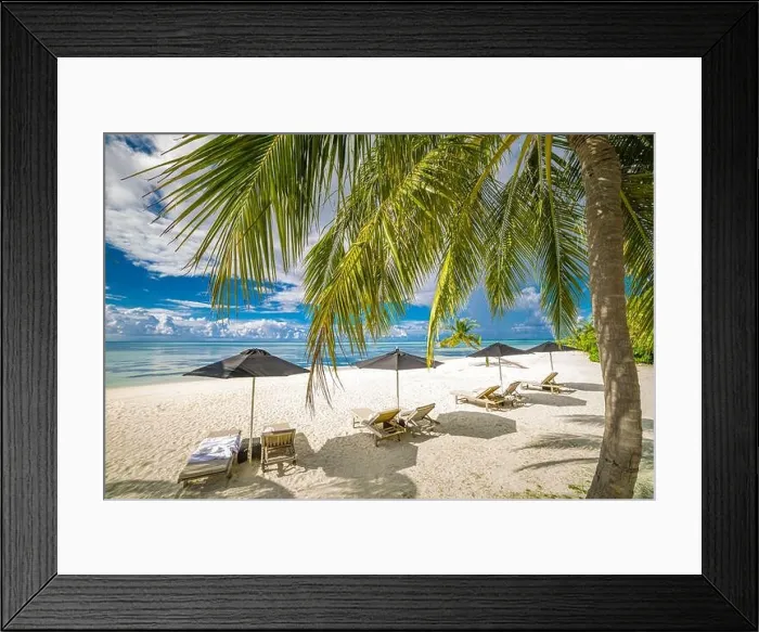 Framed Print : Tourism vacation landscape. Luxurious beach resort and beach chairs or loungers under umbrellas with palm trees and blue sky. Summer leisure carefree Framed Print : Tourism vacation landscape. Luxurious beach resort and beach chairs or loungers under umbrellas with palm trees and blue sky. Summer leisure carefree