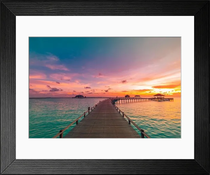Framed Print : Sunset on Maldives island, luxury water villas resort and wooden pier. Beautiful sky and clouds and beach background for summer vacation holiday Framed Print : Sunset on Maldives island, luxury water villas resort and wooden pier. Beautiful sky and clouds and beach background for summer vacation holiday