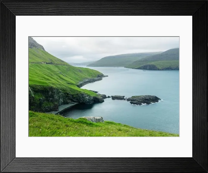 Framed Print : Dramatic view of green hills of Vagar island and Sorvagur town on background. Faroe islands, Denmark. Landscape photography