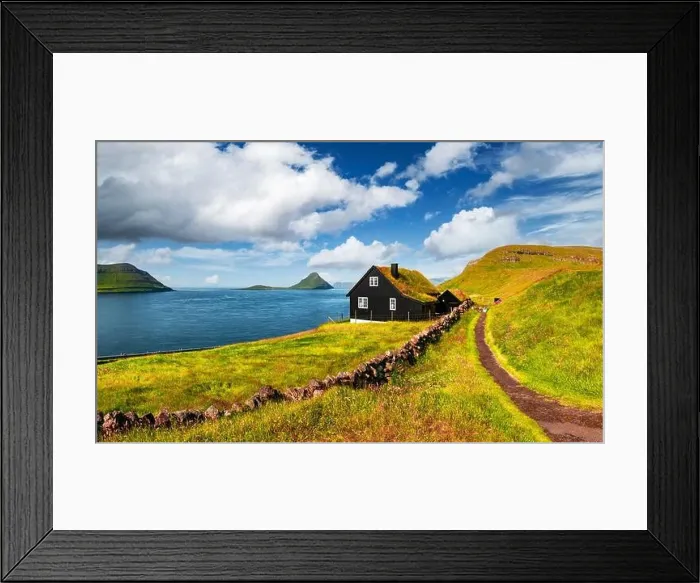 Framed Print : Foggy morning view of a house with typical turf-top grass roof and blue cloudy sky in the Velbastadur village on Streymoy island, Faroe islands, Denma Framed Print : Foggy morning view of a house with typical turf-top grass roof and blue cloudy sky in the Velbastadur village on Streymoy island, Faroe islands, Denma
