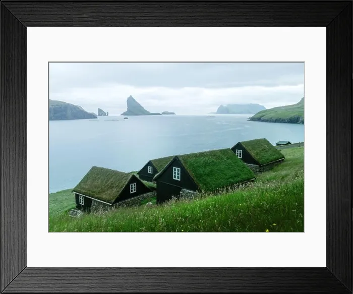 Framed Print : Picturesque view of tradicional faroese grass-covered houses in the village Bour. Drangarnir and Tindholmur sea stacks on background. Vagar island, Fa Framed Print : Picturesque view of tradicional faroese grass-covered houses in the village Bour. Drangarnir and Tindholmur sea stacks on background. Vagar island, Fa