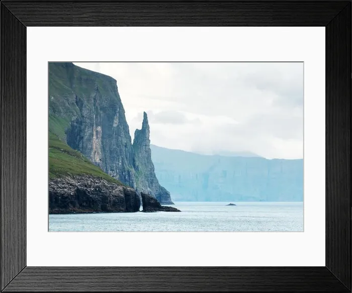Framed Print : Gorgeous faroese landscape with famous Witches Finger cliffs and dramatic cloudy sky from Trollkonufingur viewpoint. Vagar island, Faroe Islands, Denm Framed Print : Gorgeous faroese landscape with famous Witches Finger cliffs and dramatic cloudy sky from Trollkonufingur viewpoint. Vagar island, Faroe Islands, Denm