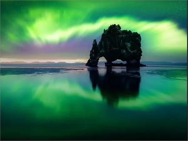 Aurora borealis (Northern lights) over Basalt stack Hvitserkur on the Vatnsnes peninsula, Iceland. Landscape photography. Courtesy of NASA