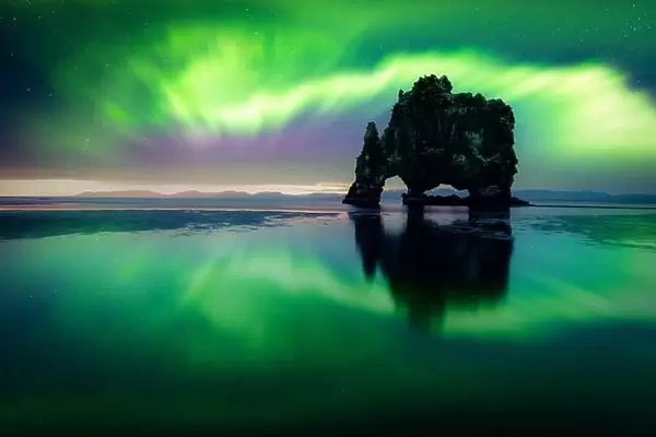 Aurora borealis (Northern lights) over Basalt stack Hvitserkur on the Vatnsnes peninsula, Iceland. Landscape photography. Courtesy of NASA