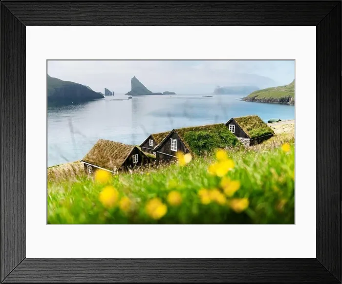 Framed Print : Picturesque view of tradicional faroese grass-covered houses in the village Bour. Drangarnir and Tindholmur sea stacks on background Framed Print : Picturesque view of tradicional faroese grass-covered houses in the village Bour. Drangarnir and Tindholmur sea stacks on background
