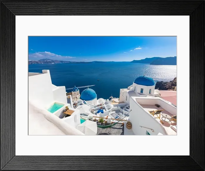 Framed Print : Amazing panoramic landscape, luxury travel vacation. Oia town on Santorini island, Greece. Traditional and famous houses and churches with blue domes Framed Print : Amazing panoramic landscape, luxury travel vacation. Oia town on Santorini island, Greece. Traditional and famous houses and churches with blue domes
