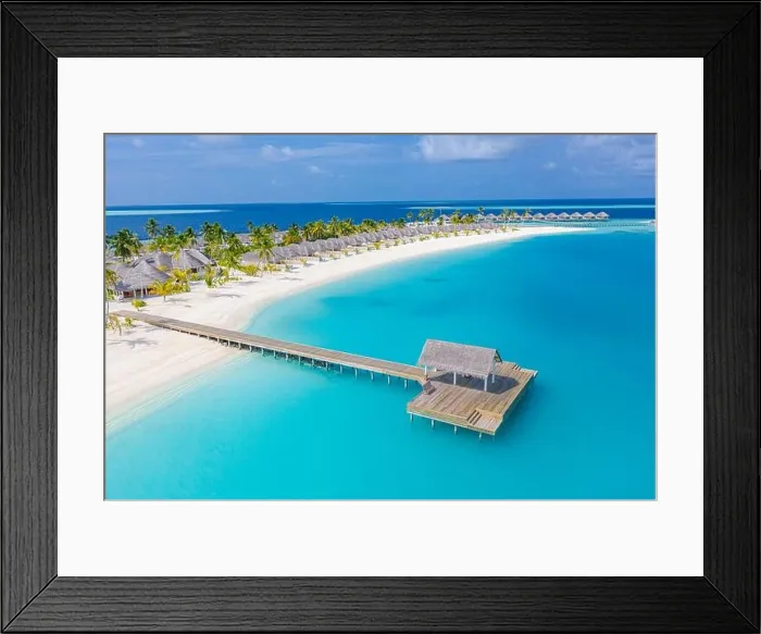 Framed Print : Aerial view of Maldives island, luxury water villas resort and wooden pier. Beautiful sky and ocean lagoon beach background. Summer vacation holiday Framed Print : Aerial view of Maldives island, luxury water villas resort and wooden pier. Beautiful sky and ocean lagoon beach background. Summer vacation holiday