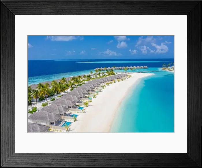 Framed Print : Aerial view of Maldives island, luxury water villas resort and wooden pier. Beautiful sky and ocean lagoon beach background. Summer vacation holiday Framed Print : Aerial view of Maldives island, luxury water villas resort and wooden pier. Beautiful sky and ocean lagoon beach background. Summer vacation holiday