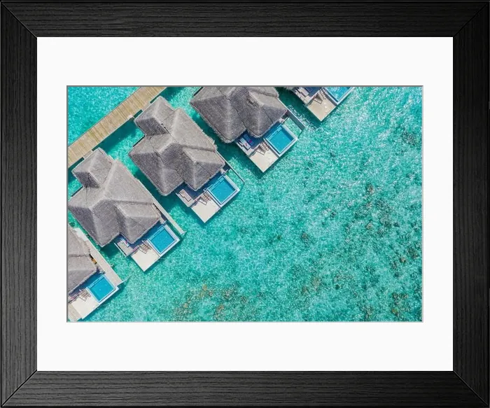 Framed Print : Aerial view of Maldives island, luxury water villas resort and wooden pier. Beautiful sky and ocean lagoon beach background. Summer vacation holiday Framed Print : Aerial view of Maldives island, luxury water villas resort and wooden pier. Beautiful sky and ocean lagoon beach background. Summer vacation holiday