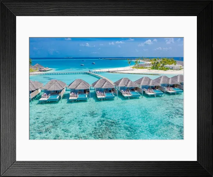 Framed Print : Aerial view of Maldives island, luxury water villas resort and wooden pier. Beautiful sky and ocean lagoon beach background. Summer vacation holiday Framed Print : Aerial view of Maldives island, luxury water villas resort and wooden pier. Beautiful sky and ocean lagoon beach background. Summer vacation holiday