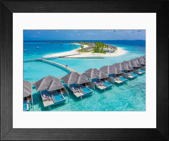 Framed Print : Aerial view of Maldives island, luxury water villas resort and wooden pier. Beautiful sky and ocean lagoon beach background. Summer vacation holiday