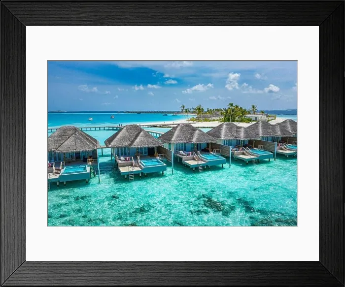 Framed Print : Aerial view of Maldives island, luxury water villas resort and wooden pier. Beautiful sky and ocean lagoon beach background. Summer vacation holiday