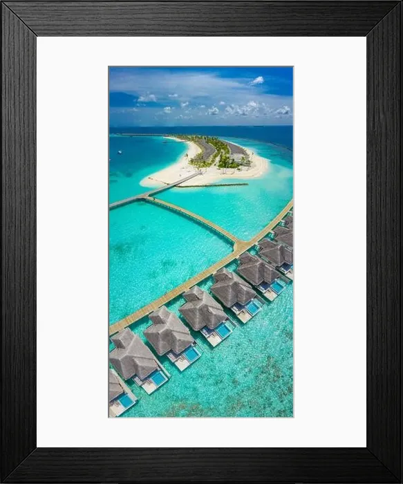 Framed Print : Aerial view of Maldives island, luxury water villas resort and wooden pier. Beautiful sky and ocean lagoon beach background. Summer vacation holiday Framed Print : Aerial view of Maldives island, luxury water villas resort and wooden pier. Beautiful sky and ocean lagoon beach background. Summer vacation holiday