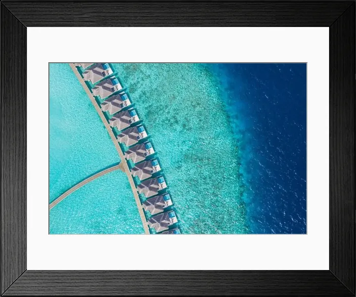 Framed Print : Aerial view of Maldives island, luxury water villas resort and wooden pier. Beautiful sky and ocean lagoon beach background. Summer vacation holiday