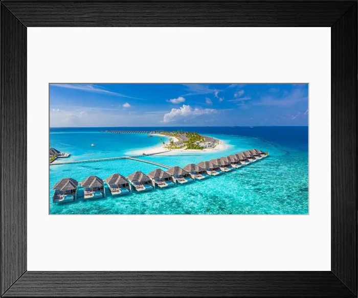 Framed Print : Aerial view of Maldives island, luxury water villas resort and wooden pier. Beautiful sky and ocean lagoon beach background. Summer vacation holiday