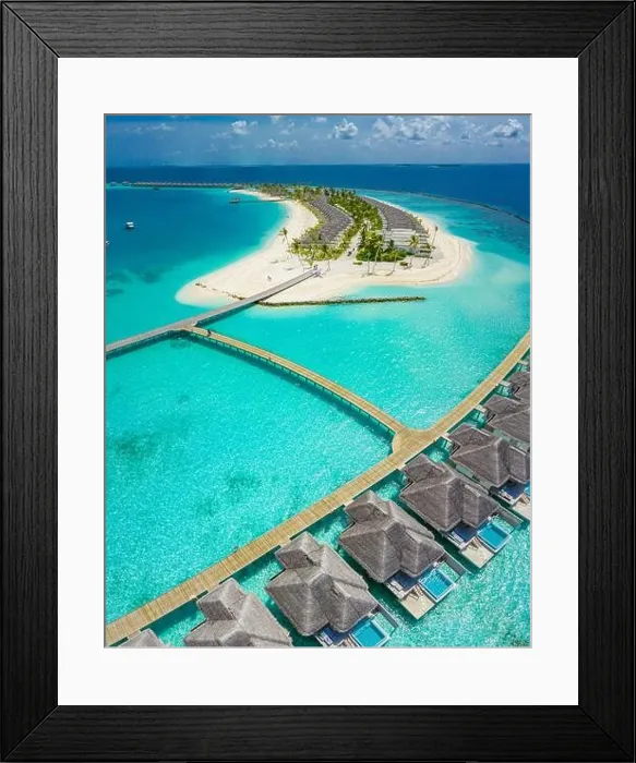 Framed Print : Aerial view of Maldives island, luxury water villas resort and wooden pier. Beautiful sky and ocean lagoon beach background. Summer vacation holiday Framed Print : Aerial view of Maldives island, luxury water villas resort and wooden pier. Beautiful sky and ocean lagoon beach background. Summer vacation holiday