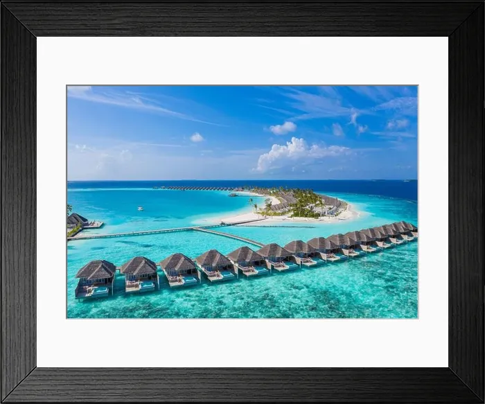 Framed Print : Aerial view of Maldives island, luxury water villas resort and wooden pier. Beautiful sky and ocean lagoon beach background. Summer vacation holiday Framed Print : Aerial view of Maldives island, luxury water villas resort and wooden pier. Beautiful sky and ocean lagoon beach background. Summer vacation holiday