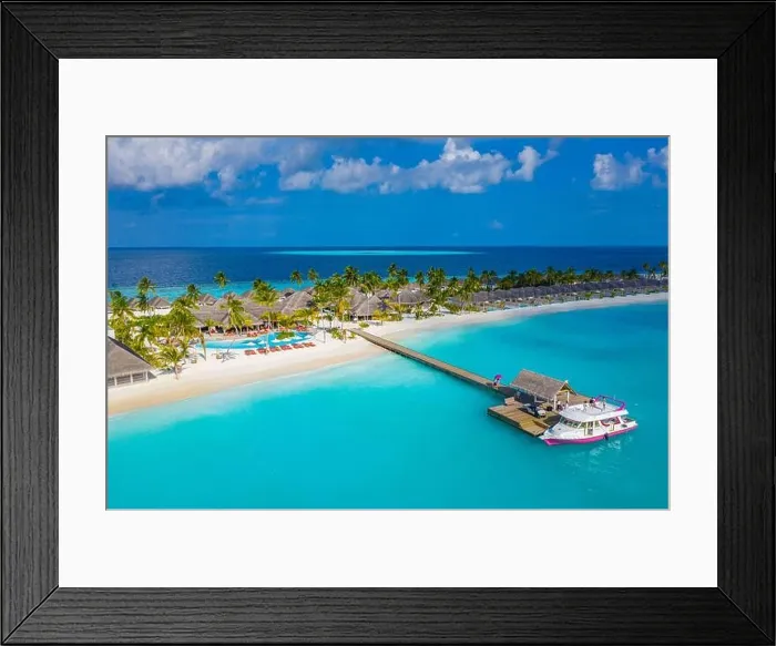 Framed Print : Aerial view of Maldives island, luxury water villas resort and wooden pier. Beautiful sky and ocean lagoon beach background. Summer vacation holiday Framed Print : Aerial view of Maldives island, luxury water villas resort and wooden pier. Beautiful sky and ocean lagoon beach background. Summer vacation holiday