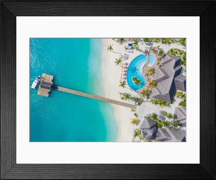 Framed Print : Aerial view of Maldives island, luxury water villas resort and wooden pier. Beautiful sky and ocean lagoon beach background. Summer vacation holiday Framed Print : Aerial view of Maldives island, luxury water villas resort and wooden pier. Beautiful sky and ocean lagoon beach background. Summer vacation holiday