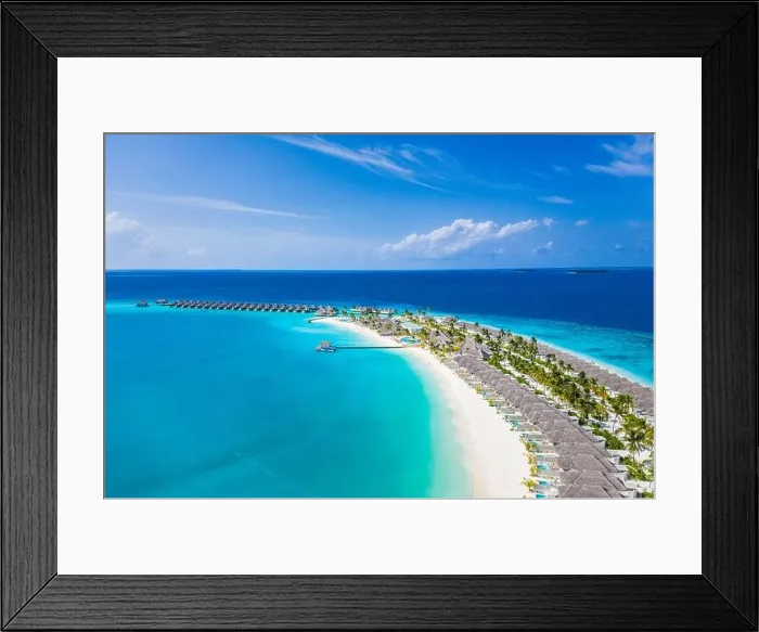 Framed Print : Aerial view of Maldives island, luxury water villas resort and wooden pier. Beautiful sky and ocean lagoon beach background. Summer vacation holiday Framed Print : Aerial view of Maldives island, luxury water villas resort and wooden pier. Beautiful sky and ocean lagoon beach background. Summer vacation holiday