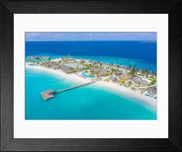 Framed Print : Aerial view of Maldives island, luxury water villas resort and wooden pier. Beautiful sky and ocean lagoon beach background. Summer vacation holiday Framed Print : Aerial view of Maldives island, luxury water villas resort and wooden pier. Beautiful sky and ocean lagoon beach background. Summer vacation holiday