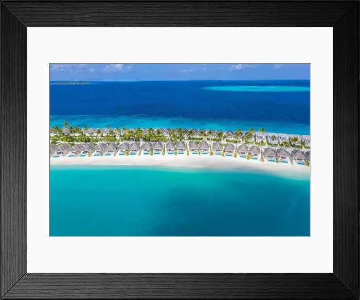 Framed Print : Aerial view of Maldives island, luxury water villas resort and wooden pier. Beautiful sky and ocean lagoon beach background. Summer vacation holiday Framed Print : Aerial view of Maldives island, luxury water villas resort and wooden pier. Beautiful sky and ocean lagoon beach background. Summer vacation holiday