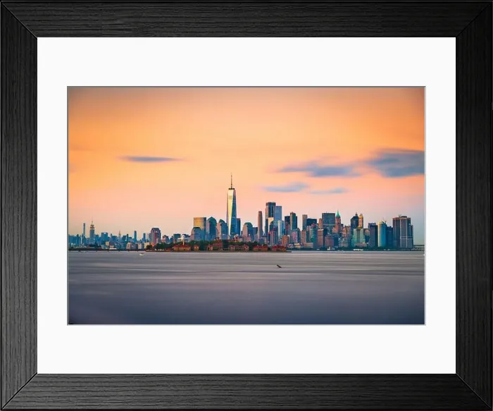 Framed Print : New York, New York, USA skyline from the harbor with Ellis Island at dusk Framed Print : New York, New York, USA skyline from the harbor with Ellis Island at dusk