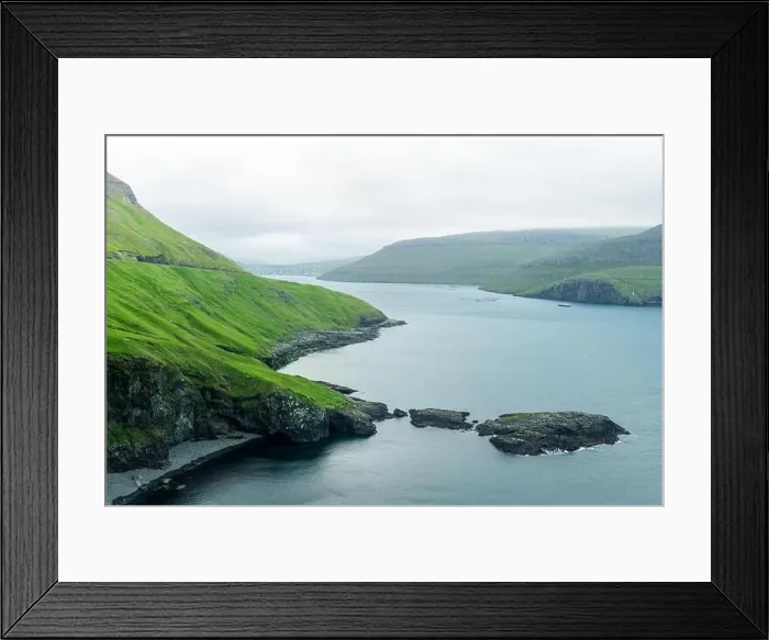 Framed Print : Dramatic view of green hills of Vagar island and Sorvagur town Framed Print : Dramatic view of green hills of Vagar island and Sorvagur town