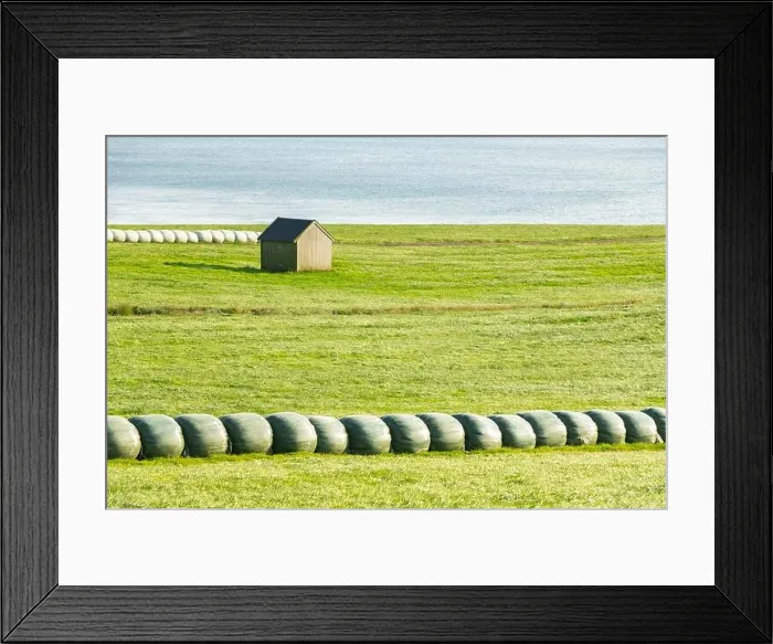 Framed Print : Rural scene with farm field and hay stacks Framed Print : Rural scene with farm field and hay stacks