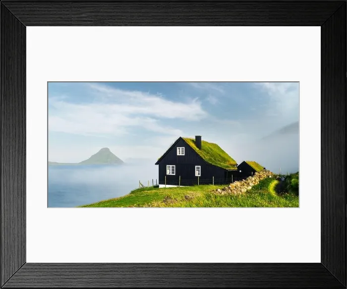Framed Print : Foggy morning view of a house with typical grass roof Framed Print : Foggy morning view of a house with typical grass roof