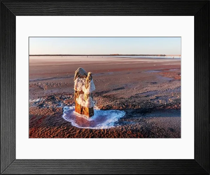 Framed Print : Tranquil landscape with dry surface of the pink salt lake with wooden post and salt crystals. Simple natural calm background Framed Print : Tranquil landscape with dry surface of the pink salt lake with wooden post and salt crystals. Simple natural calm background