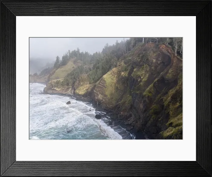 Framed Print : The Pacific Ocean washes against the rocky coastline of northern Oregon. This wild region, just west of Portland, is often covered by a dark clouds Framed Print : The Pacific Ocean washes against the rocky coastline of northern Oregon. This wild region, just west of Portland, is often covered by a dark clouds