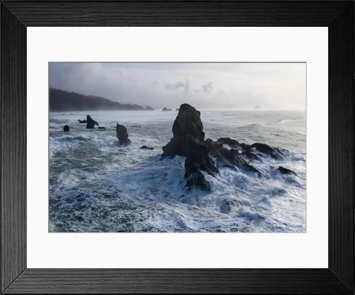 Framed Print : The Pacific Ocean crashes against rocks off the coast of northern Oregon. This wild region, just west of Portland, is often covered by a dark clouds Framed Print : The Pacific Ocean crashes against rocks off the coast of northern Oregon. This wild region, just west of Portland, is often covered by a dark clouds