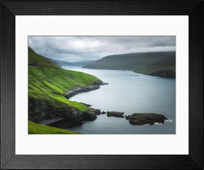 Framed Print : Dramatic view of green hills of Vagar island and Sorvagur town on background. Faroe islands, Denmark. Landscape photography Framed Print : Dramatic view of green hills of Vagar island and Sorvagur town on background. Faroe islands, Denmark. Landscape photography