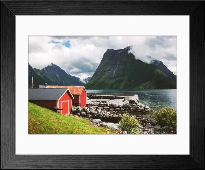 Framed Print : Picturesque scene of Urke village and Hjorundfjorden fjord, Norway. Drammatic sky and gloomy mountains. Landscape photography