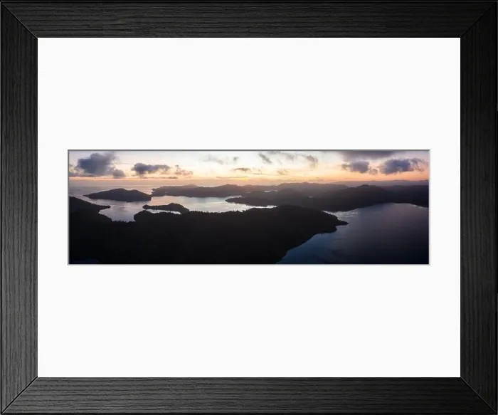Framed Print : Seen from above, sunrise illuminates islands in Raja Ampat, Indonesia. The islands are surrounded by healthy coral reefs and high marine biodiversity Framed Print : Seen from above, sunrise illuminates islands in Raja Ampat, Indonesia. The islands are surrounded by healthy coral reefs and high marine biodiversity